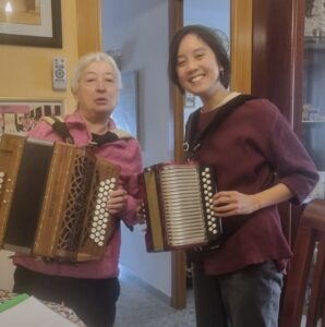 Two people playing accordions.